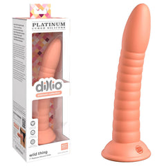 A ribbed, peach-colored silicone dildo with a rounded tip and a suction cup base is pictured next to its packaging. Made from platinum-cured silicone, the packaging is labeled "Platinum Silicone" and displays the product through a transparent window. The product name is "Dillio Platinum Wild Thing - Peach".
