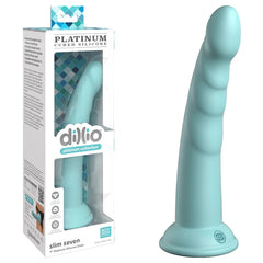 A product image of the Dillio Platinum Slim Seven - Teal, a mint green silicone dildo with a slight curve and ridged texture. Made from Platinum-cured silicone, the dildo features a strong suction cup at the base and is displayed next to its packaging, which highlights the brand name "dillio" along with product details.