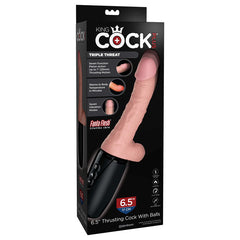 A retail box for the King Cock Plus 6.5'' Thrusting Cock with Balls showcases features such as lifelike skin and balls, internal warming, and seven powerful stimulating vibration modes. The device is depicted as a realistic-looking, flesh-colored dildo attached to a black base.