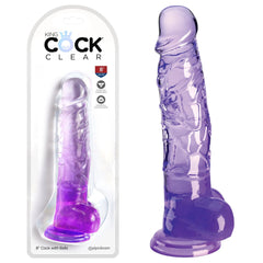 Image of the King Cock Clear 8" Cock with Balls – Purple, featuring a lifelike design with realistic details, including balls and a suction cup base. The clear, purple dildo by Pipedream is displayed both inside its transparent packaging and standing upright outside of it.
