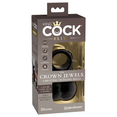 A product packaging of "King Cock Elite The Crown Jewels Vibrating Silicone Balls" by Pipedream. The front of the box showcases the Elite Silicone product inside, featuring a set of black vibrating swinging balls and highlighting its features such as vibrations, multi-speed functionality, waterproof design, and recharging capability.