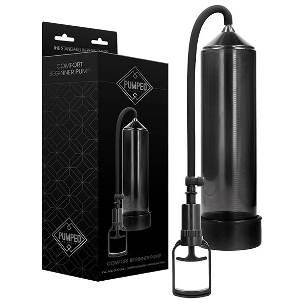 A transparent black cylindrical device with a handle is shown next to its sleek black packaging box. The box displays the product name "Pumped Comfort Beginner Penis Pump - Black" and the branding "Pumped" with a diamond logo near the top. This effective vacuum erection device offers an advanced solution for erectile dysfunction treatment.