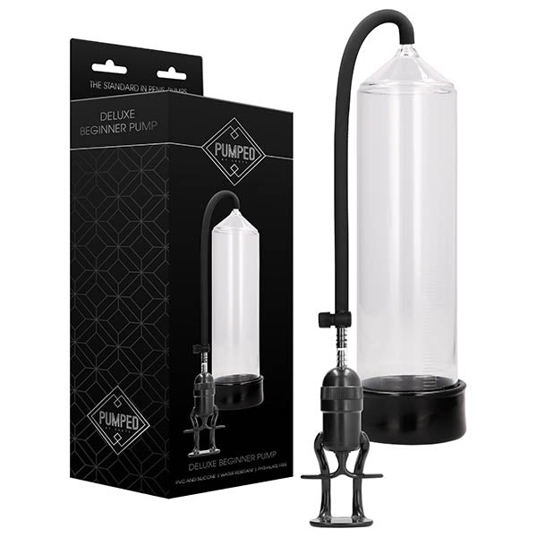 Image of a "Pumped Deluxe Beginner Penis Pump - Clear." The photo features the pump, comprising a transparent cylinder connected to a black, flexible hose with an attached hand pump. The packaging displays an image of the pump along with branding and product information for effective penis enlargement.