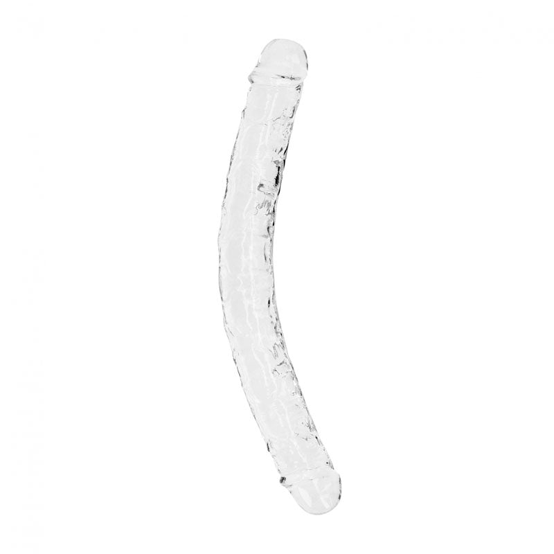 The REALROCK 34 cm Double Dong - Clear is a transparent glass sculpture shaped like a long, curved cylinder with a rounded tip at one end. The surface is textured with small ridges and bubbles, giving it an intricate appearance. This body-safe piece, crafted to be phthalate-free, is isolated against a plain white background.