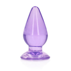 The REALROCK 11.5 cm Anal Butt Plug - Purple features a smooth, tapered design alongside a flared base. Crafted from shiny, body-safe material, it offers a sleek and polished appearance with its translucent purple finish.