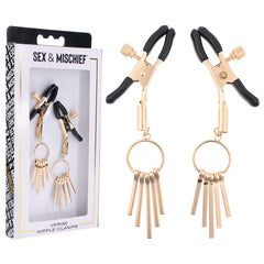 A pair of gold-colored adjustable clamps with dangling metal fringes are displayed next to their packaging. The box, named "Sex & Mischief Verge Nipple Clamps," includes a clear window that reveals the kink accessories inside.