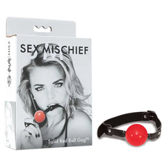 A product image features the Sex & Mischief Solid Red Ball Gag, highlighting its red ball and black straps, positioned next to its box. The box, labeled "Sex & Mischief," showcases a black and white photo of someone using the adjustable ball gag.