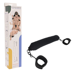 Image of a versatile pleasure device, the Pivot Positioning Bar with attached cuffs. Designed for intimate use, it’s shown next to its packaging, which displays illustrations of possible uses. The bar features a cushioned middle section with adjustable cuffs on both ends.