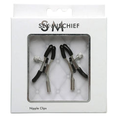 The "Sex & Mischief Nipple Clips" are packaged in a sleek, primarily white box featuring minimalistic design elements. The package includes two metal nipple clamps with rubber-tipped ends, ideal for heightening erotic pleasure during nipple play. The clips are showcased through a clear plastic window on the box labeled "Nipple Clips.