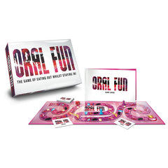 Image of the playful trivia game "Oral Fun." Displayed are the game box, a game guide booklet, a pathway-filled game board, and multiple game cards. The tagline on the box reads "The game of eating out whilst staying in!" with a color scheme that is predominantly pink and white.