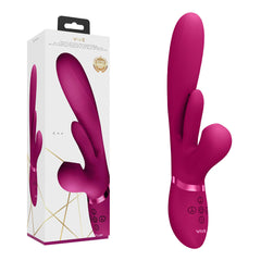 A pink VIVE Ena G-spot Rabbit Vibrator stands next to its packaging box. The device, made from medical-grade silicone, has a smooth, curved design with dual prongs and several control buttons at the base. The box features an image of the vibrator along with branding details.