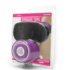 A clear plastic package includes a black blindfold and a purple roll of WhipSmart Bondage Tape - Purple 30 Metre, perfect for fetish play. The package label displays "whipSmart" at the top, "BONDAGE TAPE" in large pink letters, and "2-PACK SET" in smaller white font.