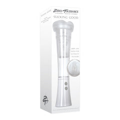 A product box for the "Zero Tolerance Sucking Good Penis Pump Masturbator" with the tagline "Sucking Good." The box features an image of a white and silver vibrating masturbator, described as gripping and sucking for ultimate pleasure. The text mentions it is made of silicone, rechargeable, and offers powerful vacuum suction.